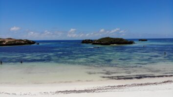 Small rocky islands surrounded by turquoise water and white sandy beaches, seen from above