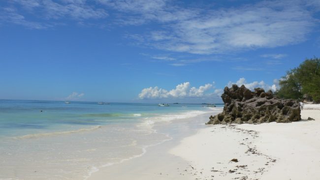 Here are alt texts for each image: 1. (top left) White sandy beach "White sandy beach with a small rocky islet and turquoise shallow waters at low tide